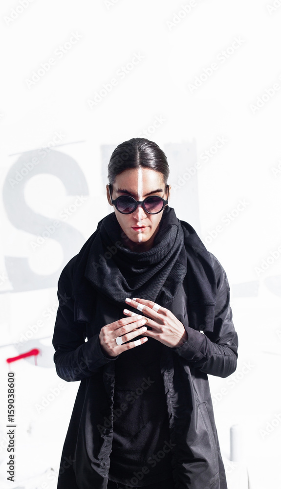 Portrait of attractive alterantive female in black urban outfit on white abstract background Portrait of attractive alterantive female in black urban outfit on white abstract background