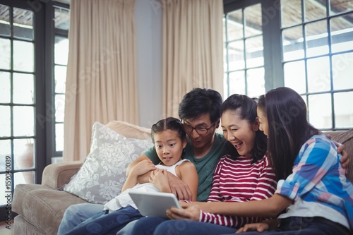 Smiling family using digital tablet together in living room © WavebreakMediaMicro
