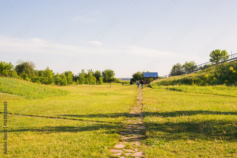 Man and woman holding hands and walking on country road Man and woman holding hands and walking on country road