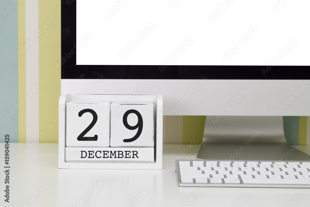 Cube shape calendar for DECEMBER 29 and computer keyboard on table. Cube shape calendar for DECEMBER 29 and computer keyboard on table.
