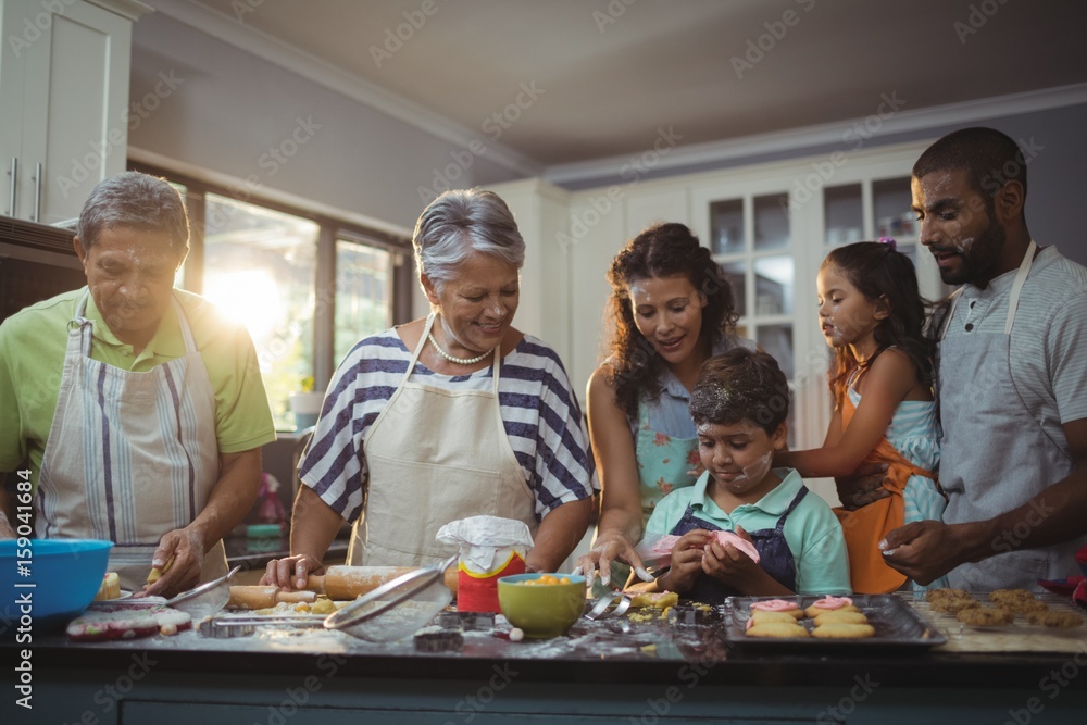 Happy family preparing dessert in kitchen Happy family preparing dessert in kitchen