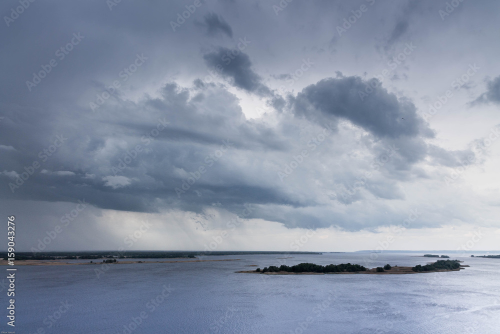 An uneasy and gloomy sky above the river. Waiting for rain and thunderstorms.