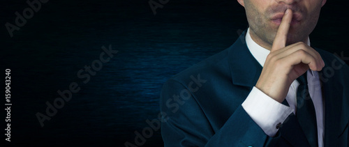 Fotografía Businessman making silence gesture, pst.