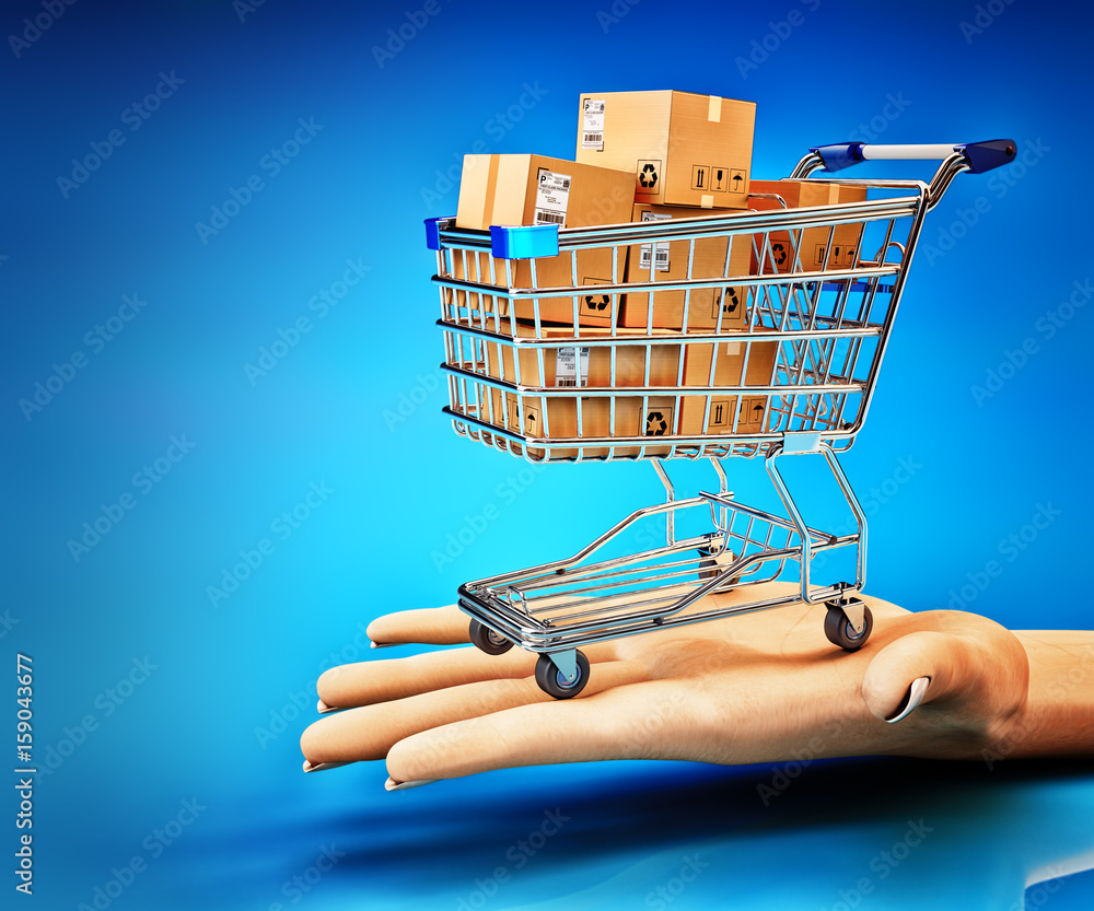 Commercial offer and purchase concept, shopping cart full of cardboard boxes on human hand palm on blue background