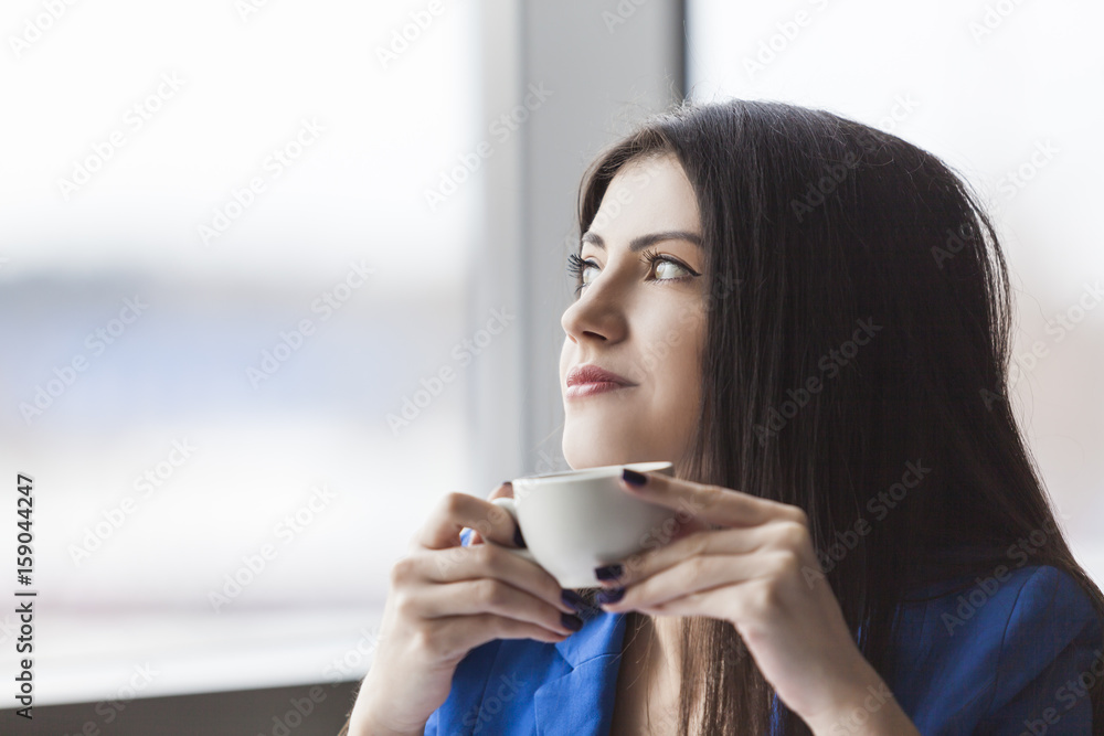 Close up of pensive businesswoman with coffee cup Close up of pensive businesswoman with coffee cup