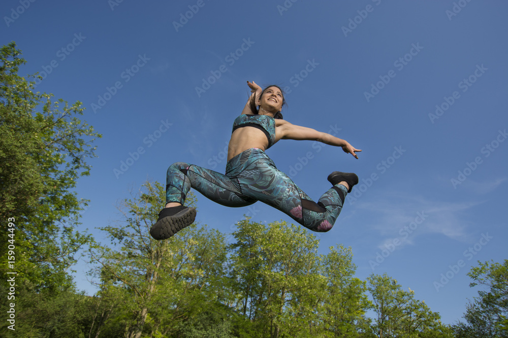 Fit young girl posing for camera during outdoor gym exercises Fit young girl posing for camera during outdoor gym exercises