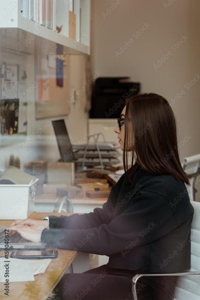Female executive working on laptop in office Female executive working on laptop in office