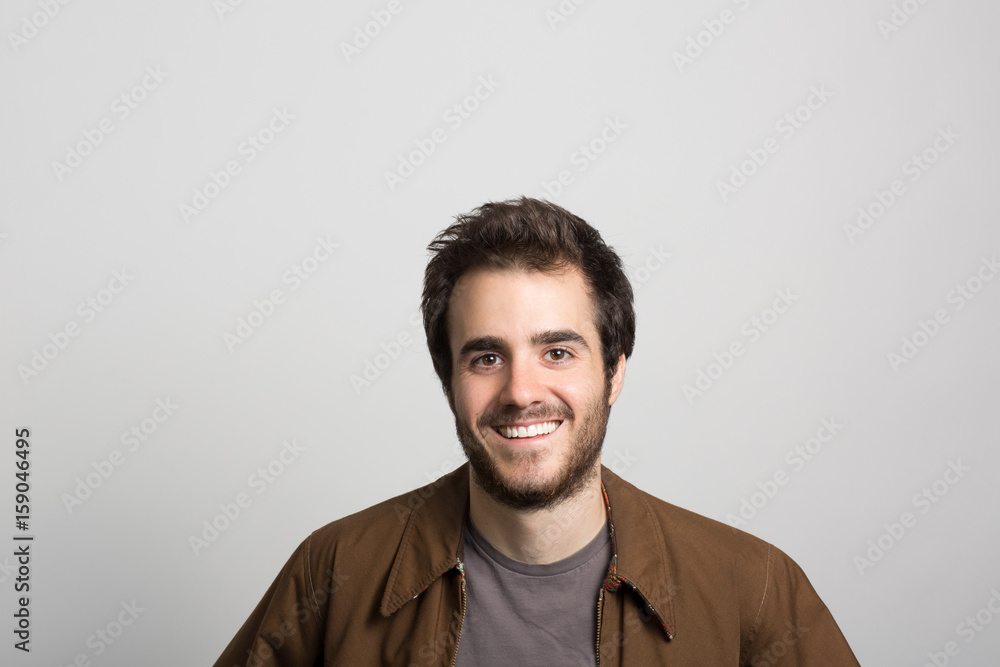 studio portrait of a happy young man
