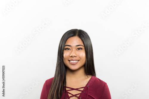 studio portrait of a happy young woman