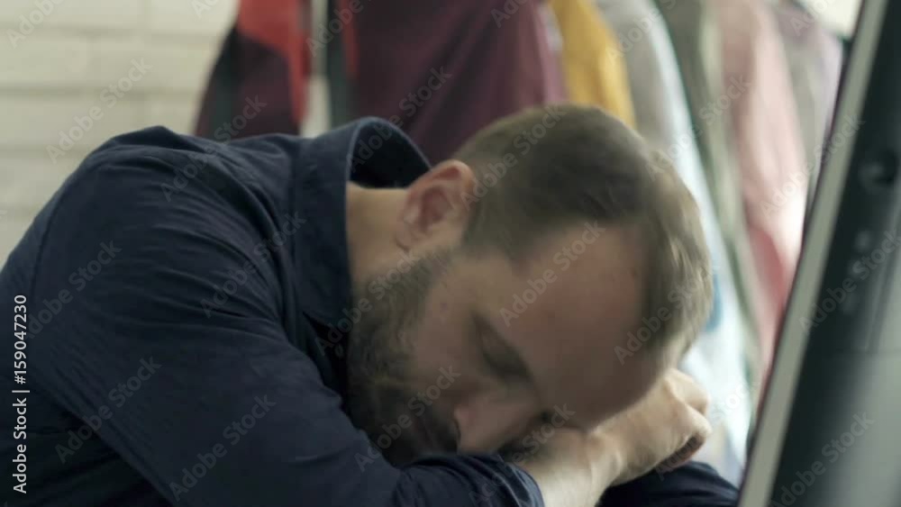 Tired man yawning and falling asleep by table at home
Tired man yawning and falling asleep by table at home