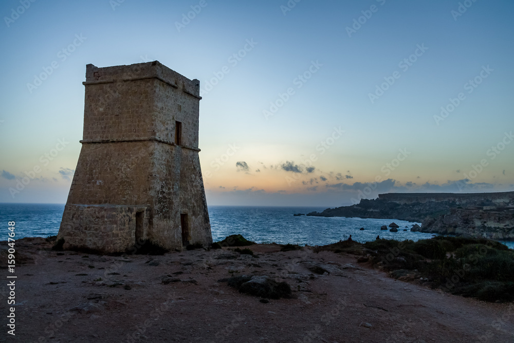 Ghajn Tuffieha Tower in Golden Bay at sunset - Malta Ghajn Tuffieha Tower in Golden Bay at sunset - Malta