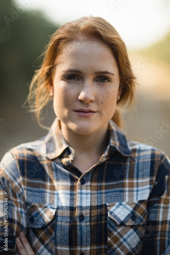 Portrait of beautiful young woman at farm 