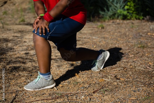 Boy performing stretching exercise 