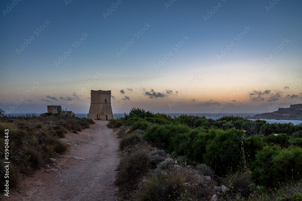 Ghajn Tuffieha Tower in Golden Bay at sunset - Malta