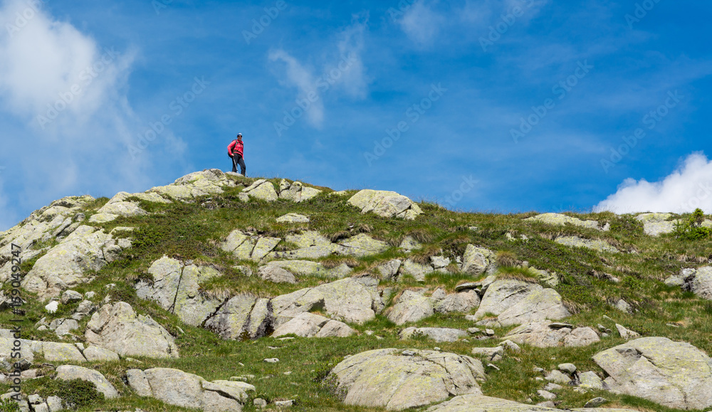 Naklejka premium Trekker walking along a ridge.