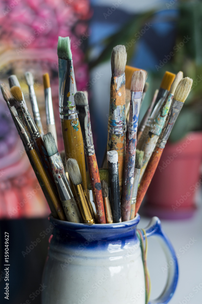 Fototapeta premium diferent brushes in multicolored paint closeup a