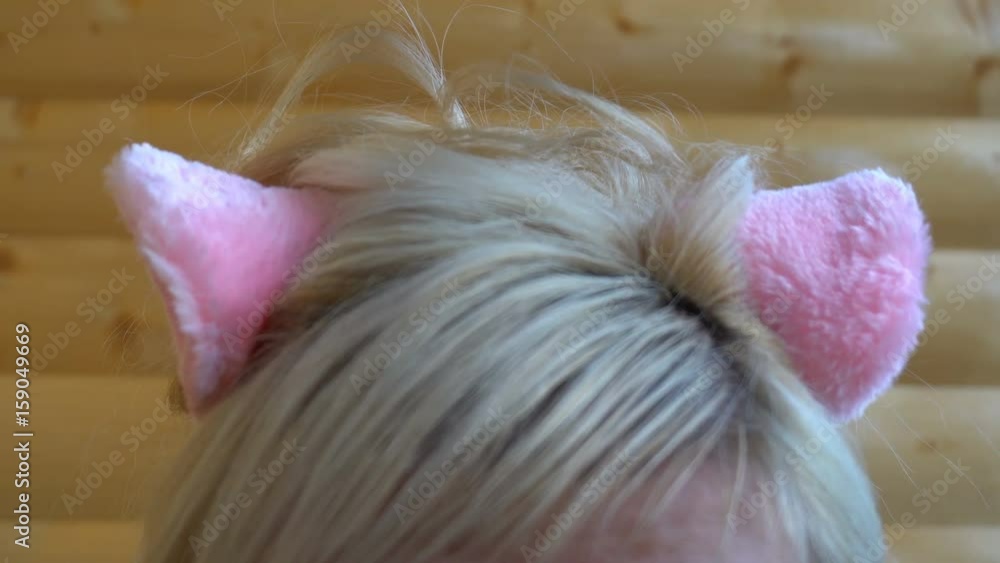 pink cat ears on the head of the girl. pink cat ears on the head of the girl.