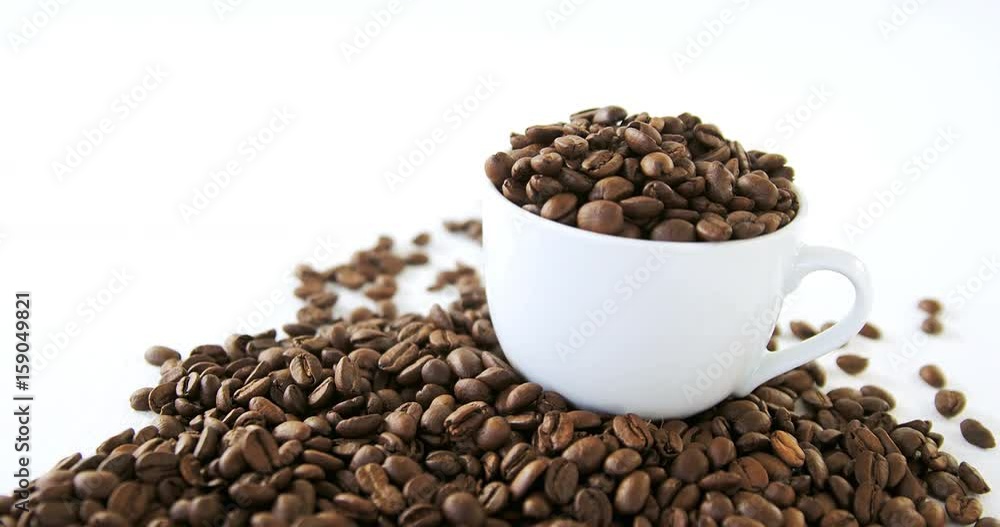 Cup of coffee filled with roasted coffee beans Cup of coffee filled with roasted coffee beans