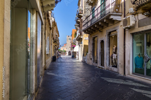 Street view of Taormina city with Clock Tower on background - Taormina, Sicily, Italy