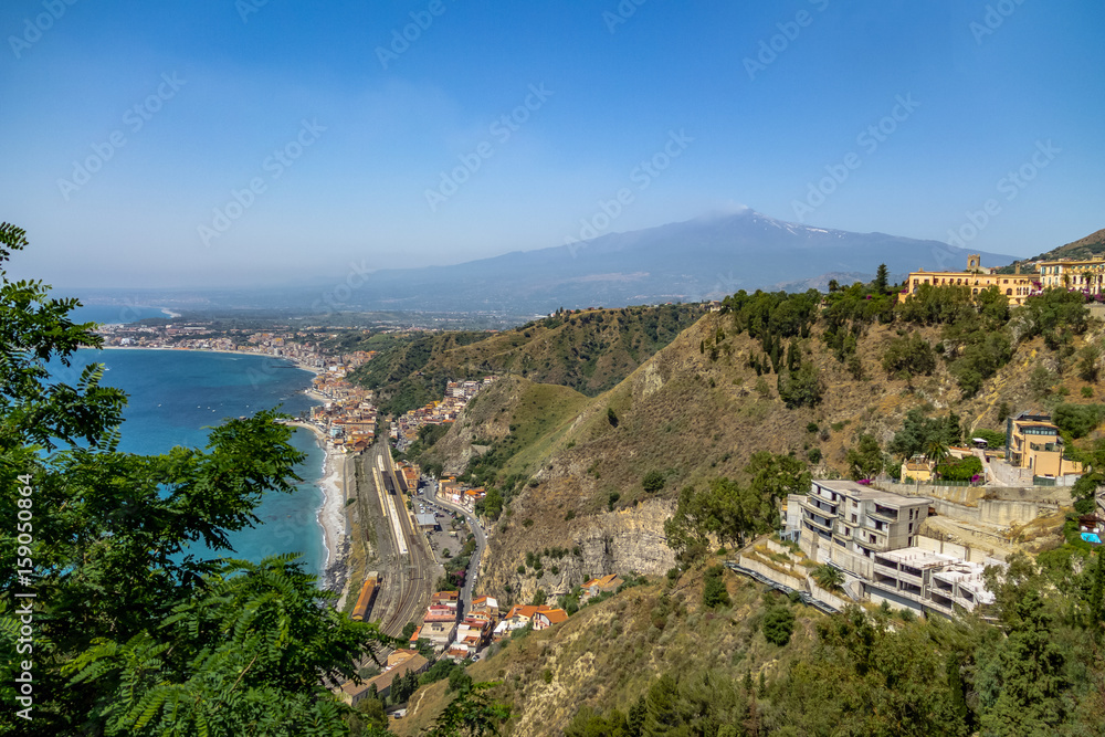 Obraz premium Aerial view of Taormina city, mediterranean sea and Mount Etna Volcano - Taormina, Sicily, Italy