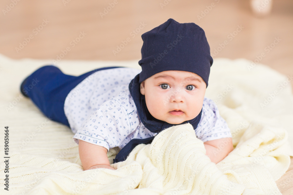 Adorable baby boy in white sunny bedroom. Newborn child. Adorable baby boy in white sunny bedroom. Newborn child.