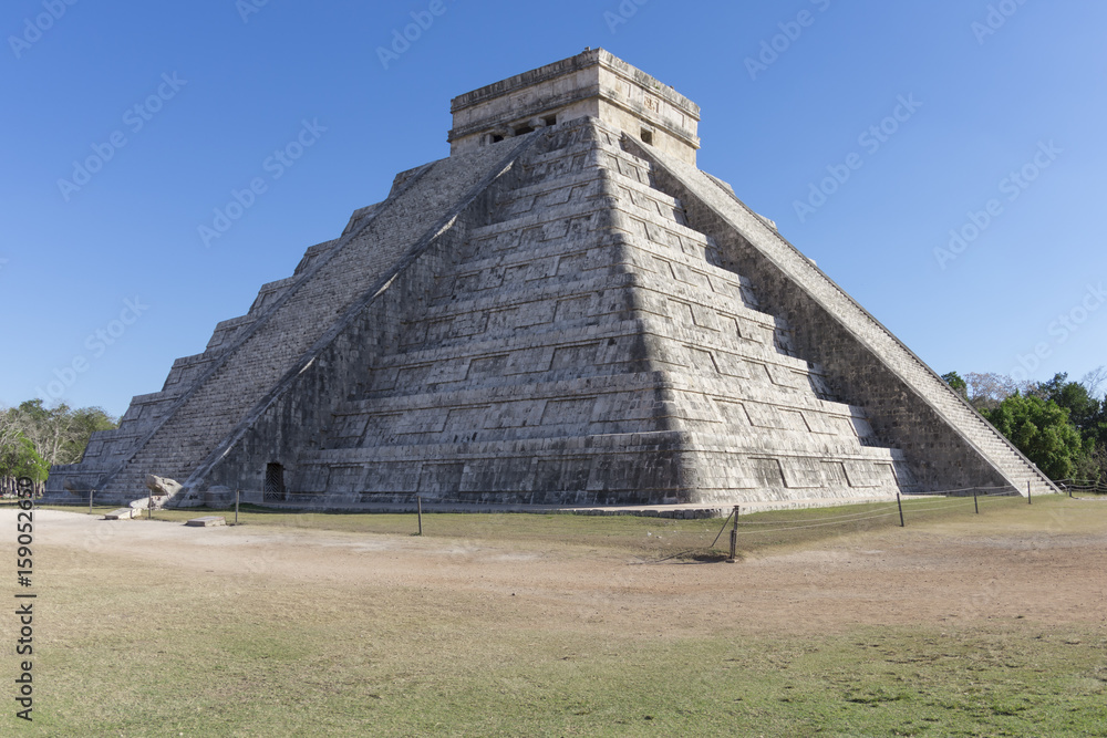 El Castillo pyramid at Chichen Itza with blue sky