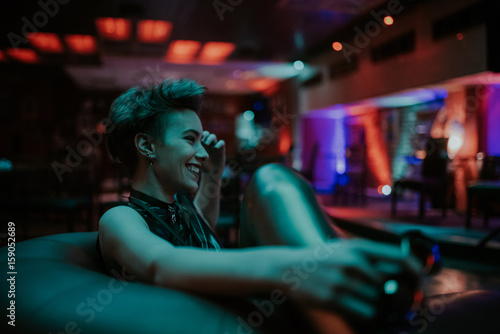 Young attractive woman smiling at the club at night photo