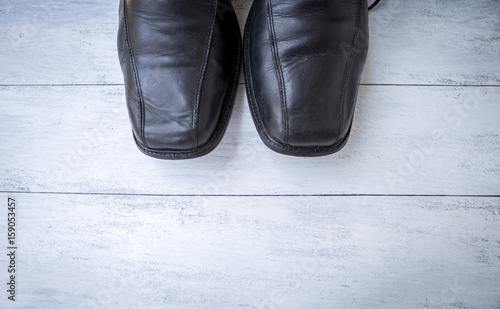 Old men black leather shoes on white wood texture background, father's day concept background © sirirak