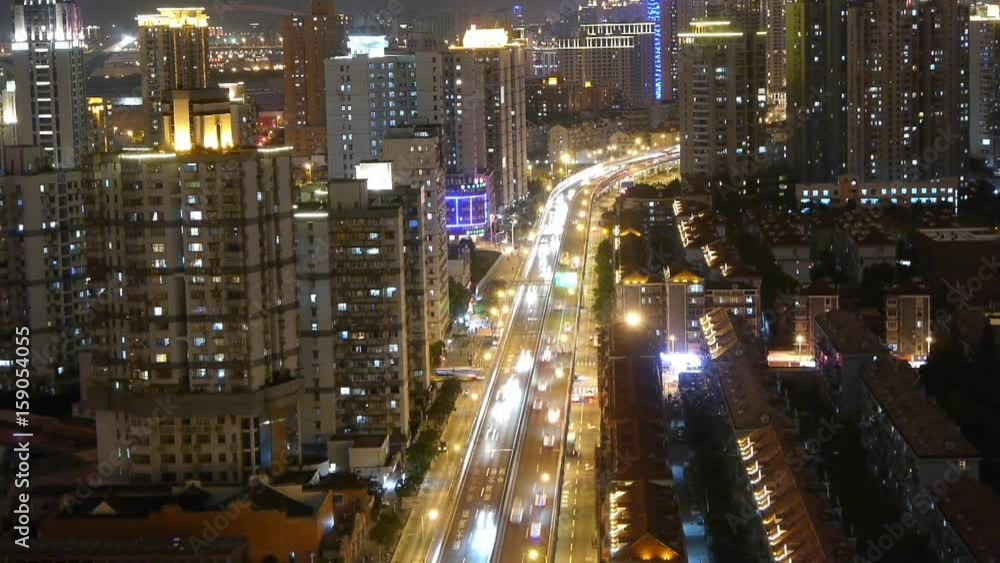 freeway busy city rush hour heavy traffic jam highway Shanghai at night,the light trails of traffic with super long exposures,timelapse,Brightly lit urban morden building. freeway busy city rush hour heavy traffic jam highway Shanghai at night,the light trails of traffic with super long exposures,timelapse,Brightly lit urban morden building.