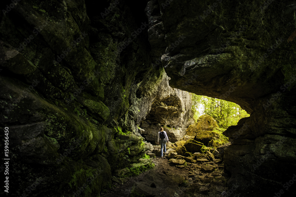 Woman Hiking Through Limestone Cave On The Niagara Escarpment Woman Hiking Through Limestone Cave On The Niagara Escarpment