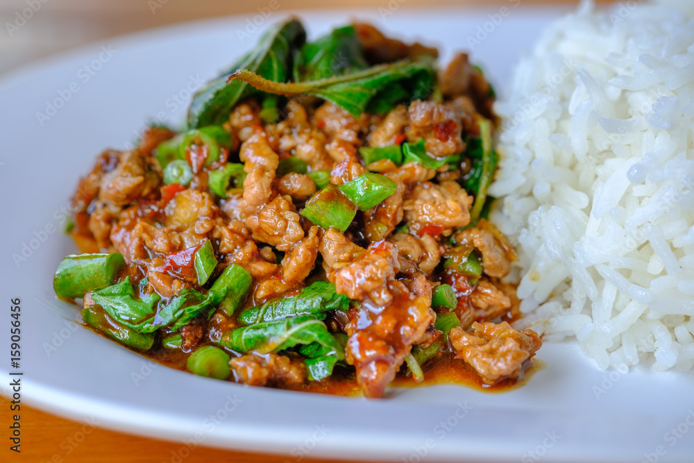 fried beef with basil and rice in dish