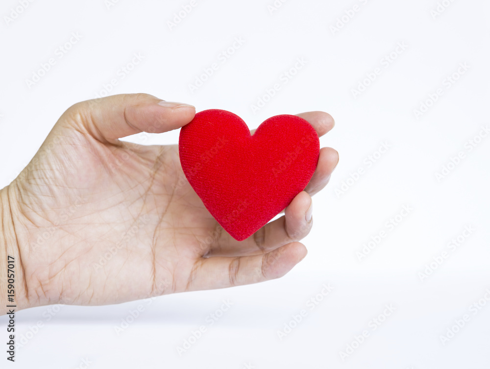 Girl hand holding red heart on white background, valentine concept Girl hand holding red heart on white background, valentine concept