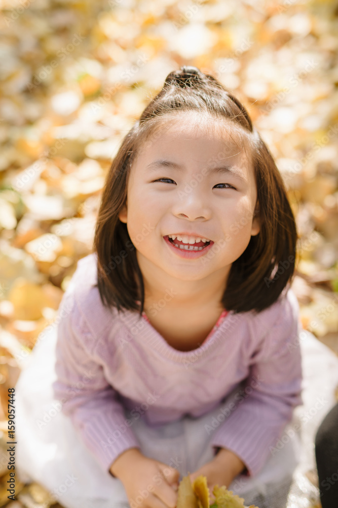 Young girl playing leaf in autumn wood Young girl playing leaf in autumn wood