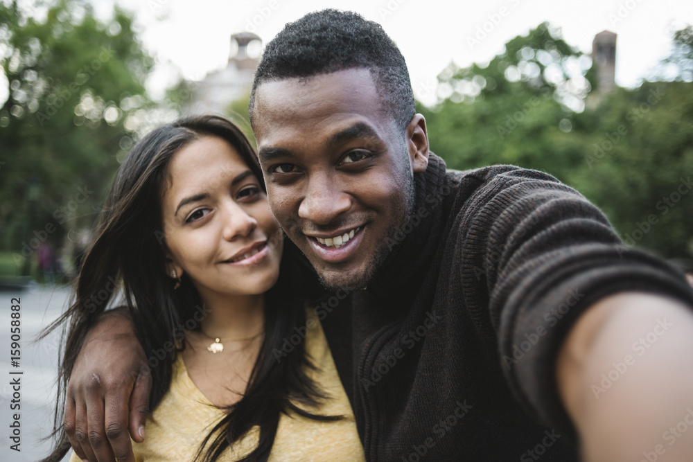 Black young couple taking a selfie in the city Black young couple taking a selfie in the city