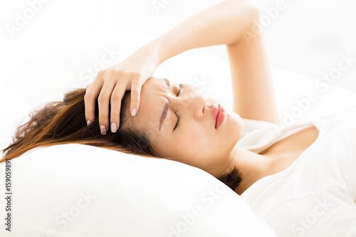 young Woman with headache in bed
