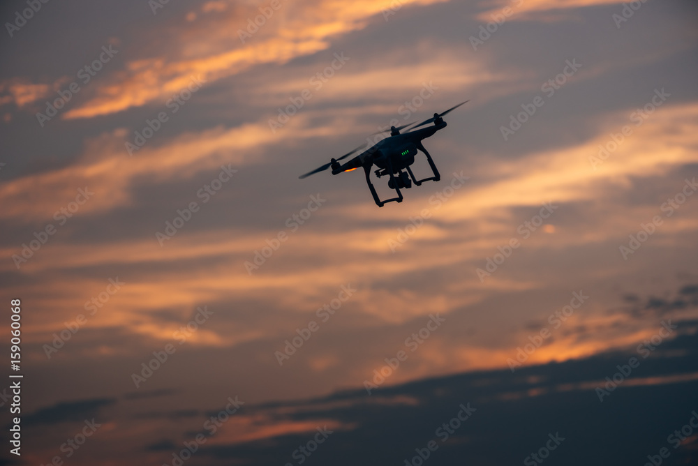 Drone flying against cloudy sky Drone flying against cloudy sky