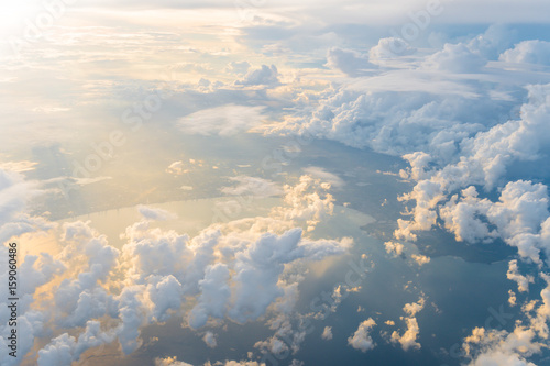 Fototapeta Naklejka Na Ścianę i Meble -  White clouds and blue sky at sunrise, view from above air plane window.