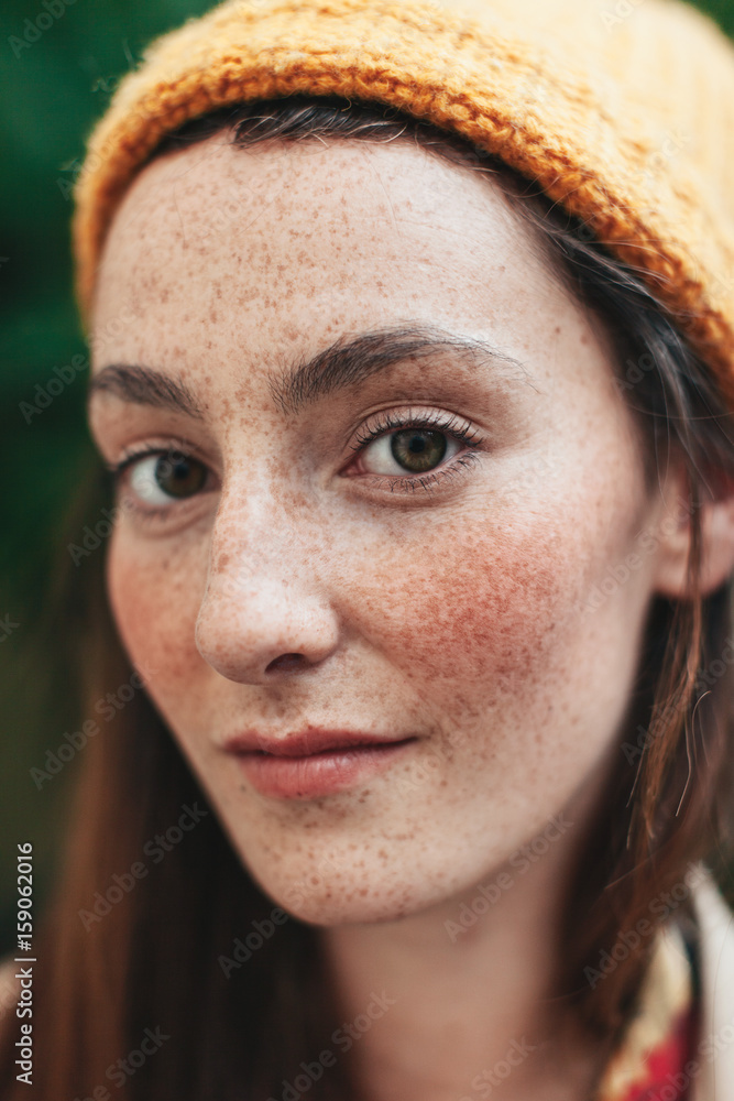 Portrait of young freckled woman with yellow bonnet Portrait of young freckled woman with yellow bonnet