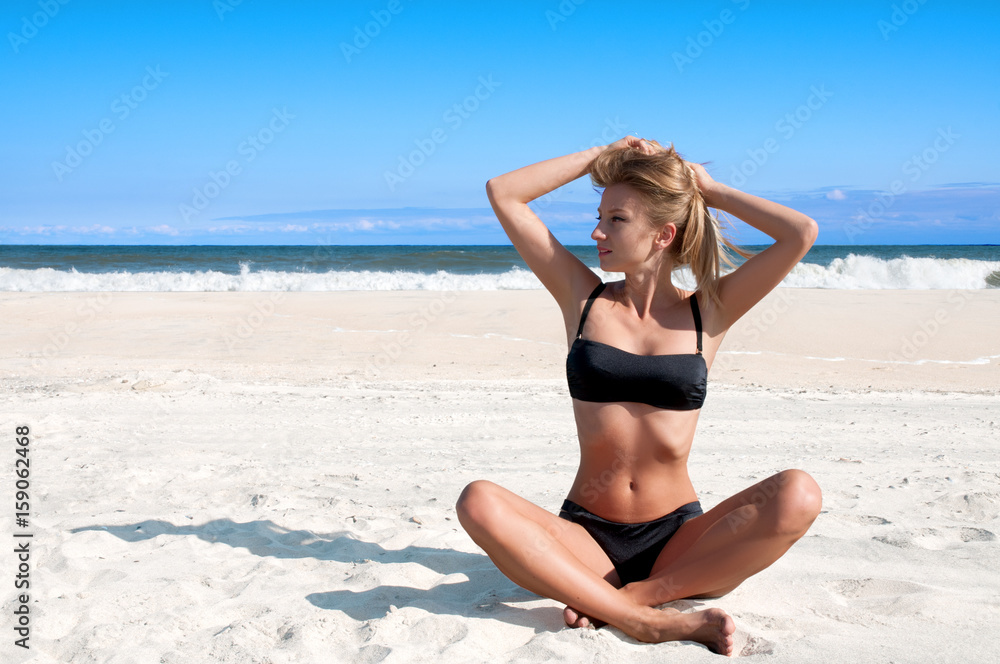 Beach vacation. Beautiful tanned woman in bikini relaxing on the tropical beach Beach vacation. Beautiful tanned woman in bikini relaxing on the tropical beach