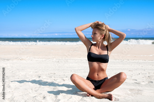 Beach vacation. Beautiful tanned woman in bikini  relaxing on the tropical beach © Dmytro Flisak