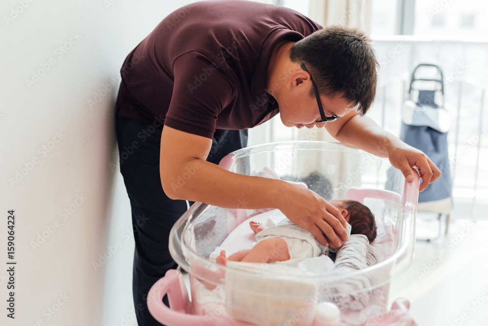 Father looking at his newborn baby for the first time Father looking at his newborn baby for the first time