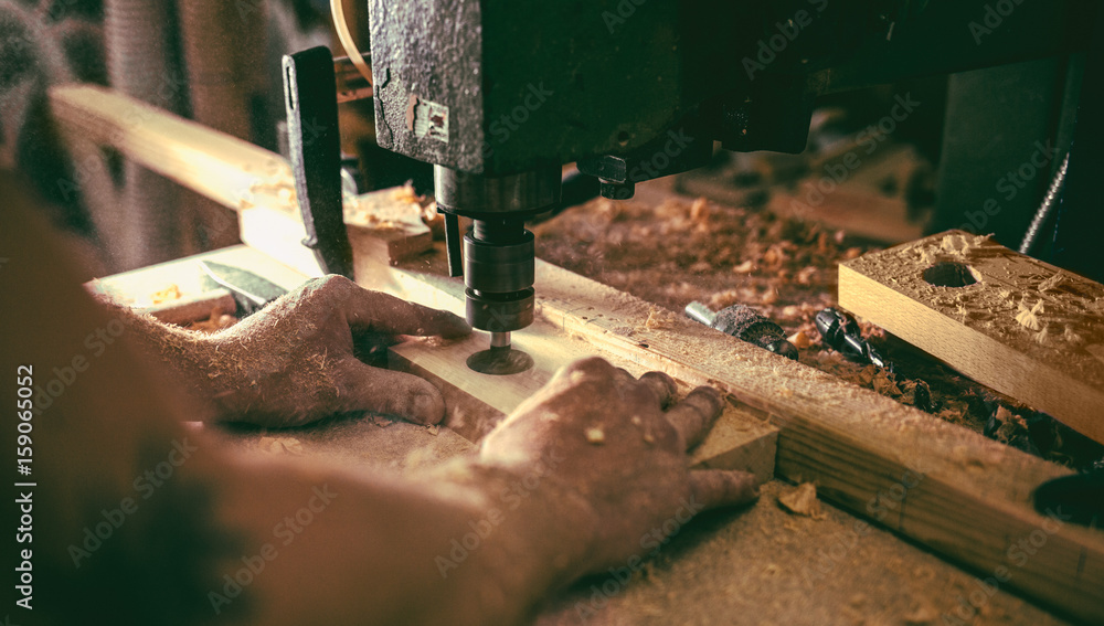 Carpenter Drilling a Hole Carpenter Drilling a Hole