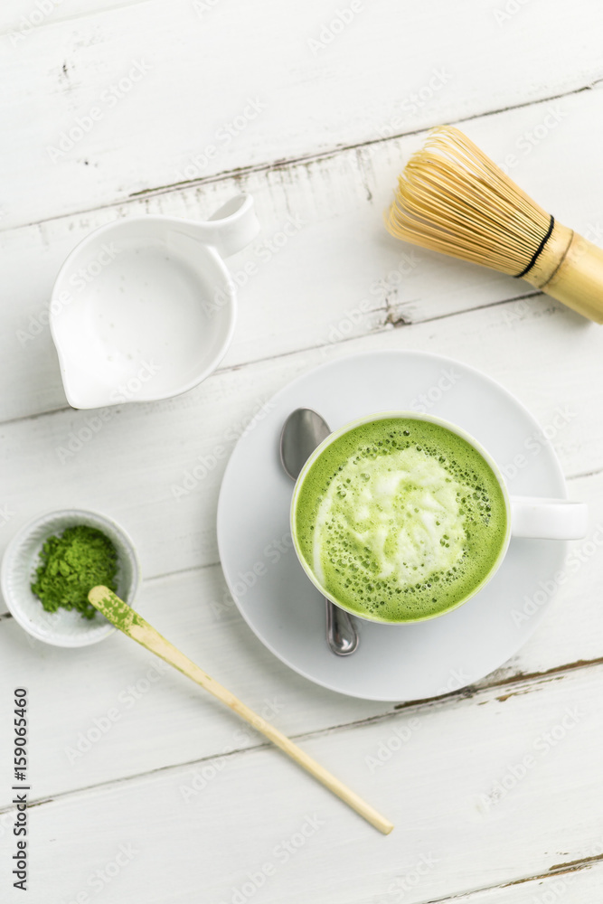 Green tea matcha latte vertical top view. This latte is a delicious way to enjoy the energy boost & healthy benefits of matcha. Matcha is a powder of green tea leaves packed with antioxidants. Green tea matcha latte vertical top view. This latte is a delicious way to enjoy the energy boost & healthy benefits of matcha. Matcha is a powder of green tea leaves packed with antioxidants.
