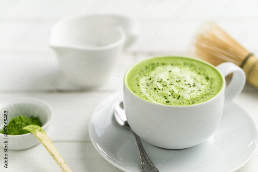 Matcha latte cup close up background blurred. This latte is a delicious way to enjoy the energy boost & healthy benefits of matcha. Matcha is a powder of green tea leaves packed with antioxidants. Matcha latte cup close up background blurred. This latte is a delicious way to enjoy the energy boost & healthy benefits of matcha. Matcha is a powder of green tea leaves packed with antioxidants.