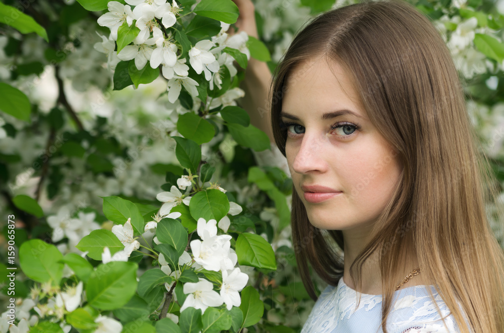 Girl posing against a background of flowering trees / Photographed in Russia, in the city of Orenburg Girl posing against a background of flowering trees / Photographed in Russia, in the city of Orenburg