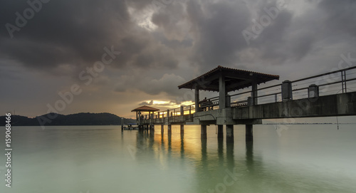 Golden light at Jetty with long exposure and dramatic clouds