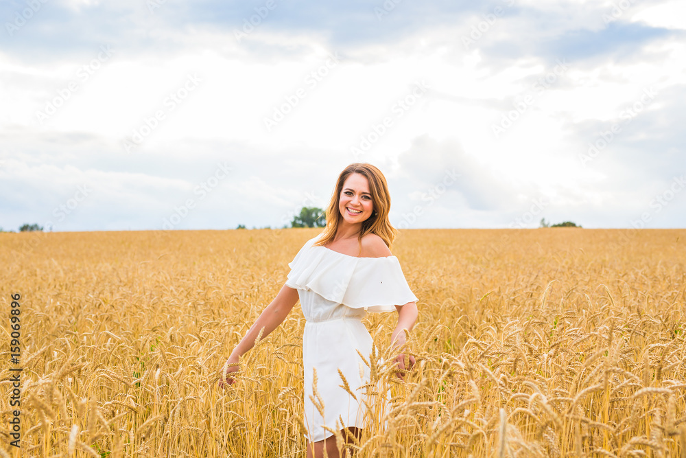 happiness, nature, summer, autumn, vacation and people concept - young woman in the field. happiness, nature, summer, autumn, vacation and people concept - young woman in the field.