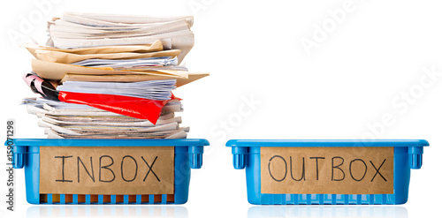 Procrastination - A full Inbox tray and an empty Outbox tray - Overwhelmed - Isolated on white background photo