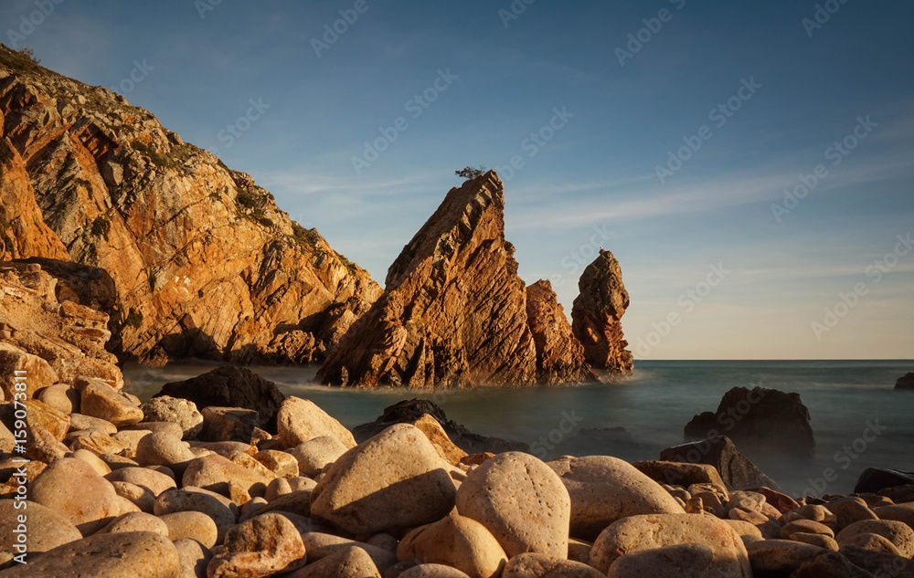 Amazing Wild rock beach at the sunset. Sintra Cascais Natural Park Portugal