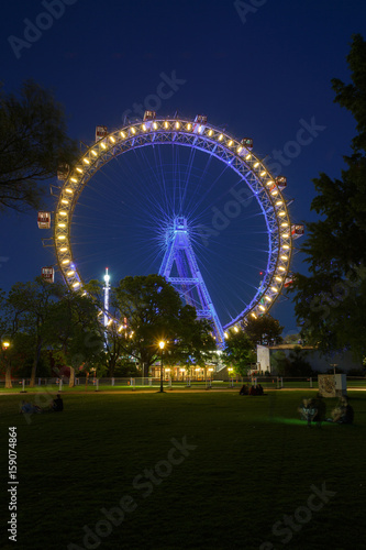 Photography Night view of the illuminated Riesenrad ferris wheel in the Prater amusement par